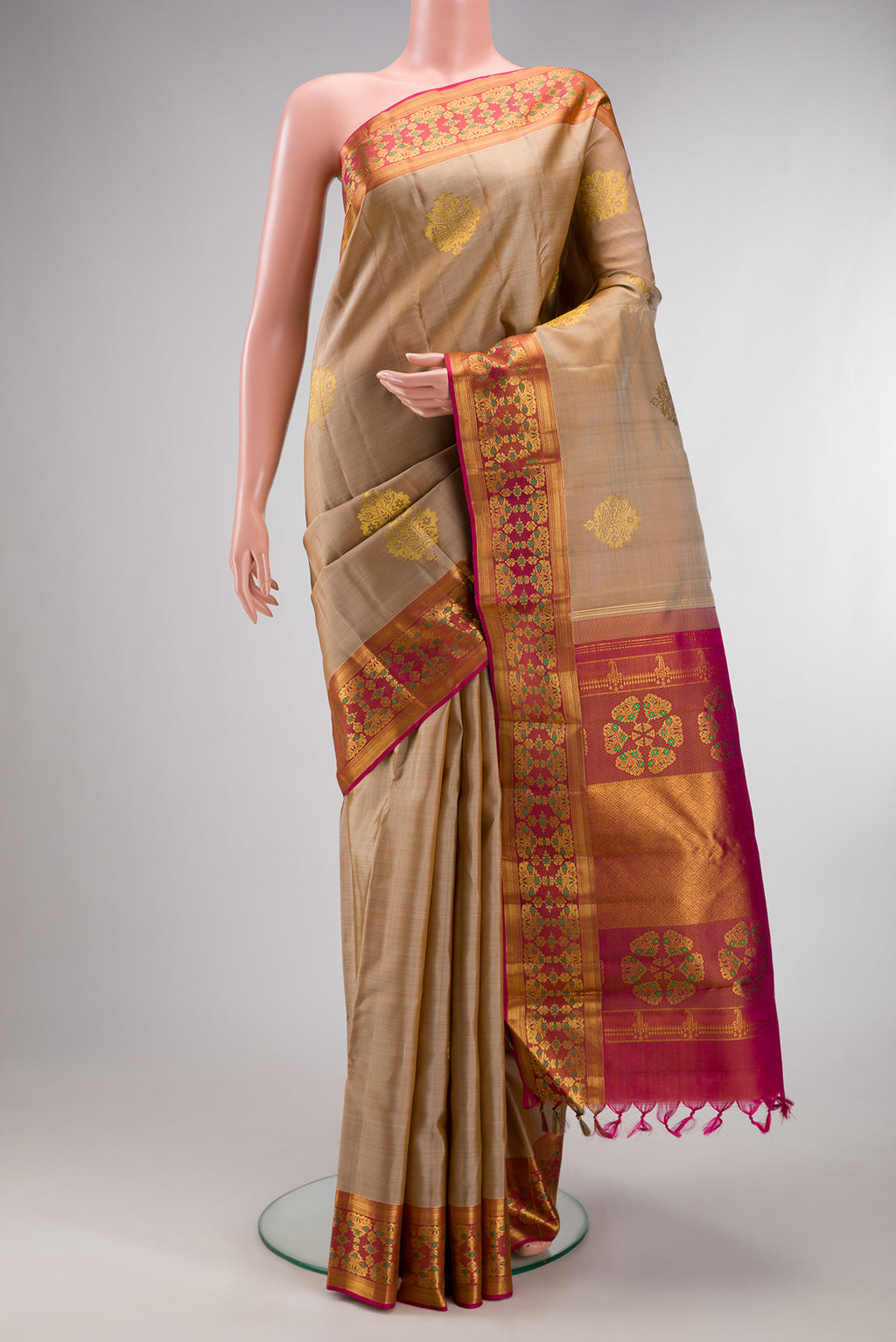 Pure Silk Beige Kanchipuram Saree with Zari Butta on the body and Fancy Border.  displayed on a mannequin