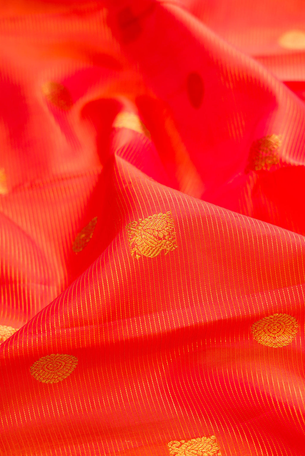 Close up of Pure Silk Orange Kanjivaram Saree with Stripes on the body and Zari Border.  displaying folds