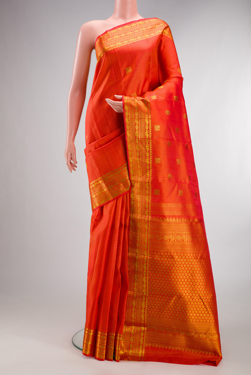 Pure Silk Orange Kanjivaram Saree with Stripes on the body and Zari Border.  displayed on a mannequin