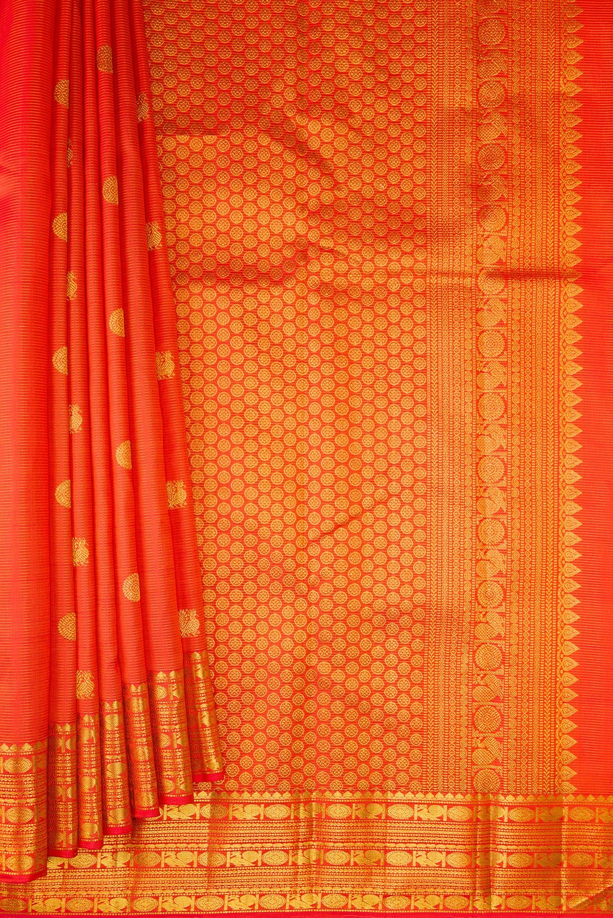 Pleats and pallu of Pure Silk Orange Kanjivaram Saree with Stripes on the body and Zari Border. 