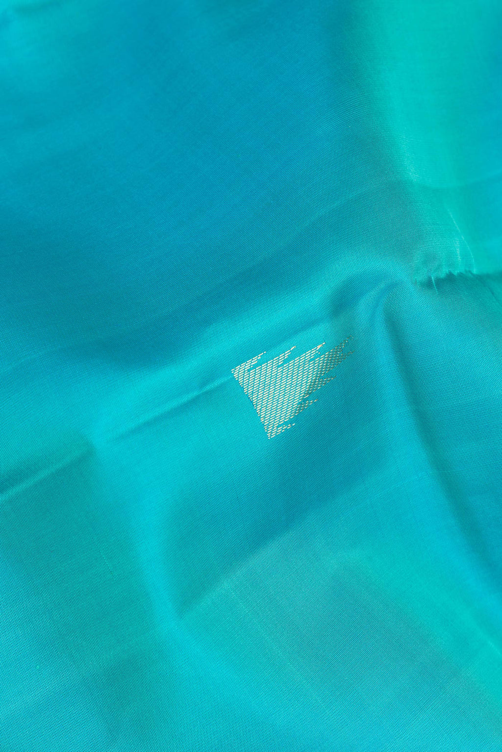 Close up of Pure Silk Sky Blue Kanjivaram Saree with Zari Butta on the body and Fancy Border.  displaying folds