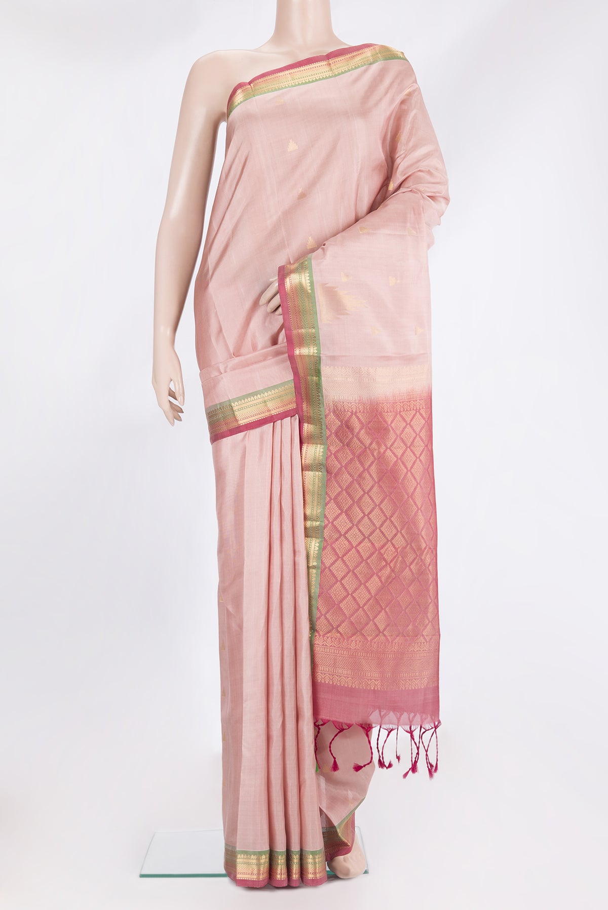 Pure Silk Rose Gold Kanchipuram Saree with Zari Butta on the body and Zari Border.  displayed on a mannequin
