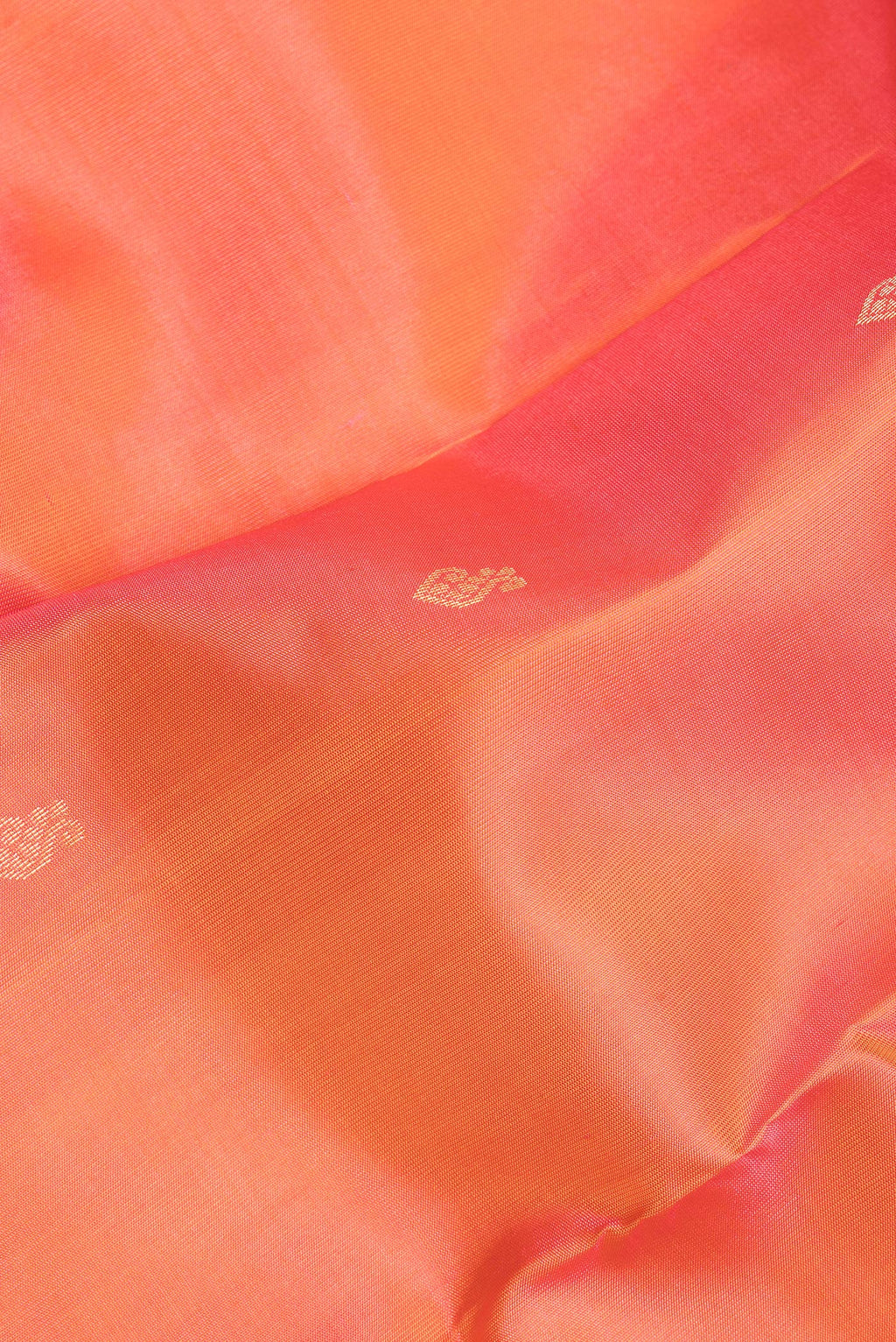 Close up of Pure Silk Golden Peach Kanchipuram Saree with Zari Butta on the body and Zari Border.  displaying folds