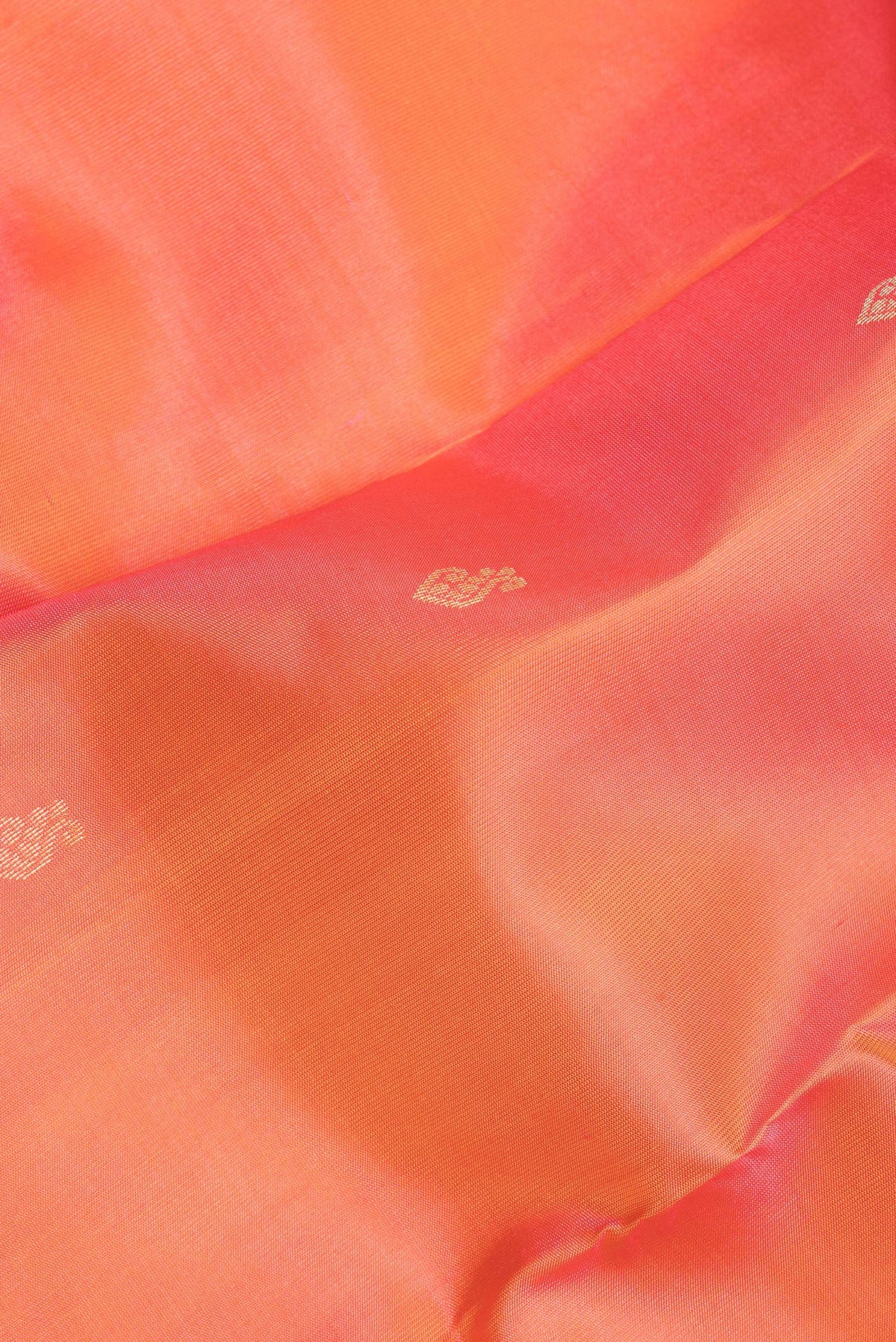 Close up of Pure Silk Golden Peach Kanchipuram Saree with Zari Butta on the body and Zari Border.  displaying folds