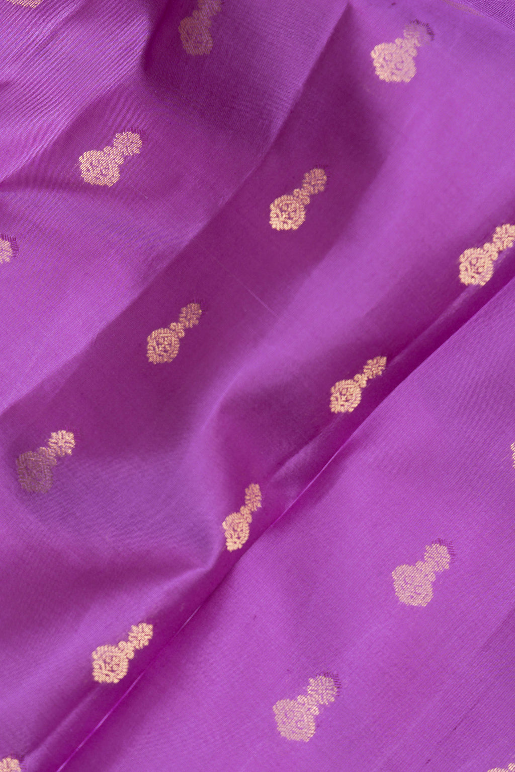 Close up of Pure Silk Purple Kanjivaram Saree with Zari Butta on the body and Zari Border.  displaying folds