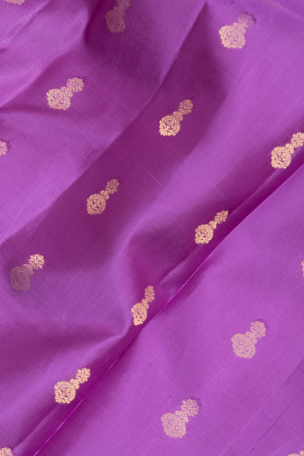 Close up of Pure Silk Purple Kanjivaram Saree with Zari Butta on the body and Zari Border.  displaying folds