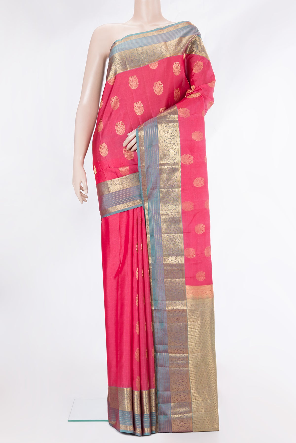 Pure Silk Coral Kanjivaram Saree with Zari Butta on the body and Zari Border.  displayed on a mannequin