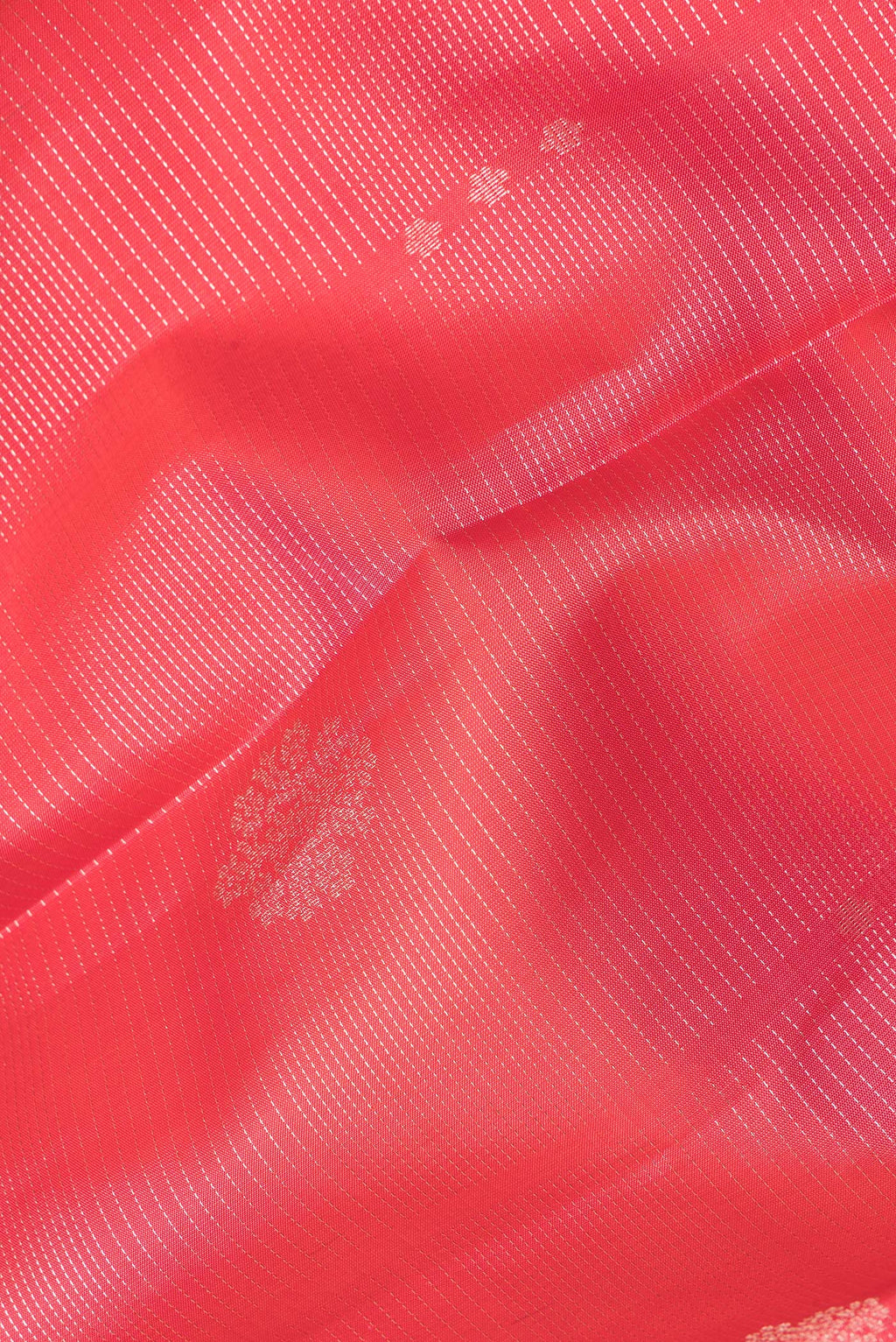 Close up of Pure Silk Orange Kanchipuram Saree with Stripes on the body and Zari Border.  displaying folds
