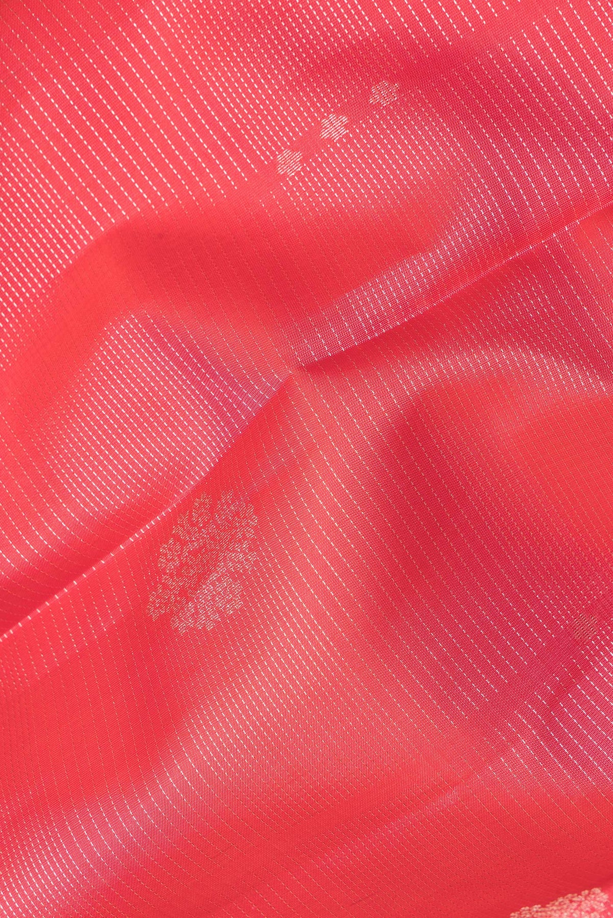 Close up of Pure Silk Orange Kanchipuram Saree with Stripes on the body and Zari Border.  displaying folds