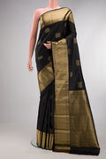Pure Silk Black Kanchipuram Saree with Zari Butta on the body and Zari Border.  displayed on a mannequin