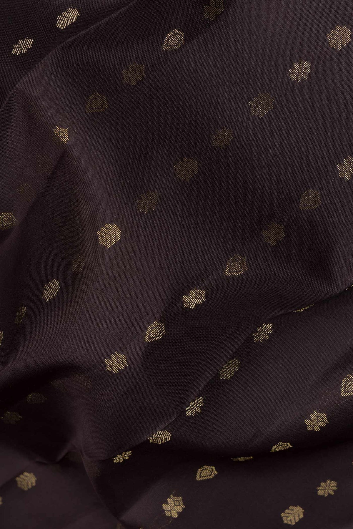 Close up of Pure Silk Coffee Brown Kanchipuram Saree with Zari Butta on the body and Zari Border.  displaying folds