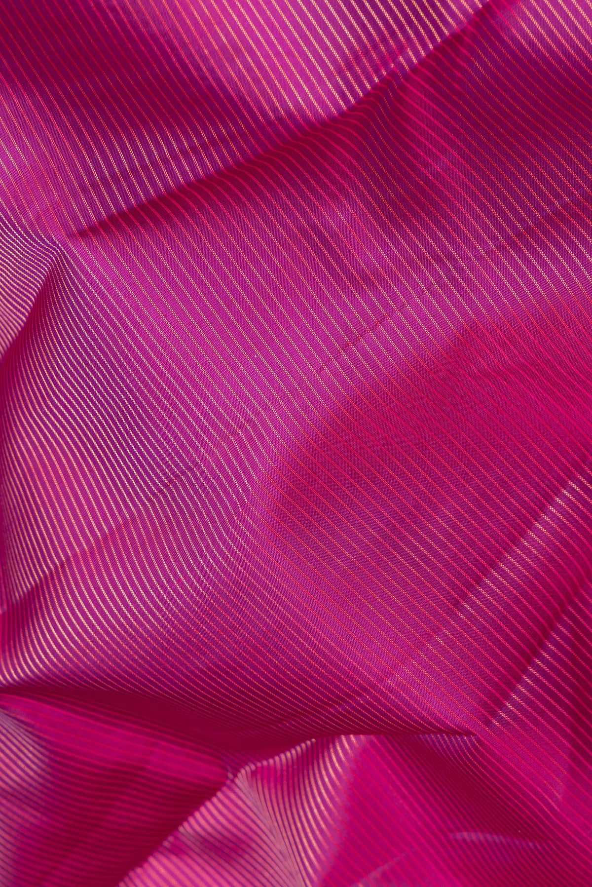Close up of Pure Silk Magenta Kanchipuram Saree with Stripes on the body and Plain Border.  displaying folds