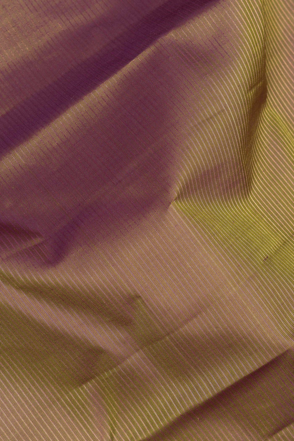 Close up of Pure Silk Mehandi Green Dual Tone Kanchipuram Saree with Stripes on the body and Fancy Border.  displaying folds