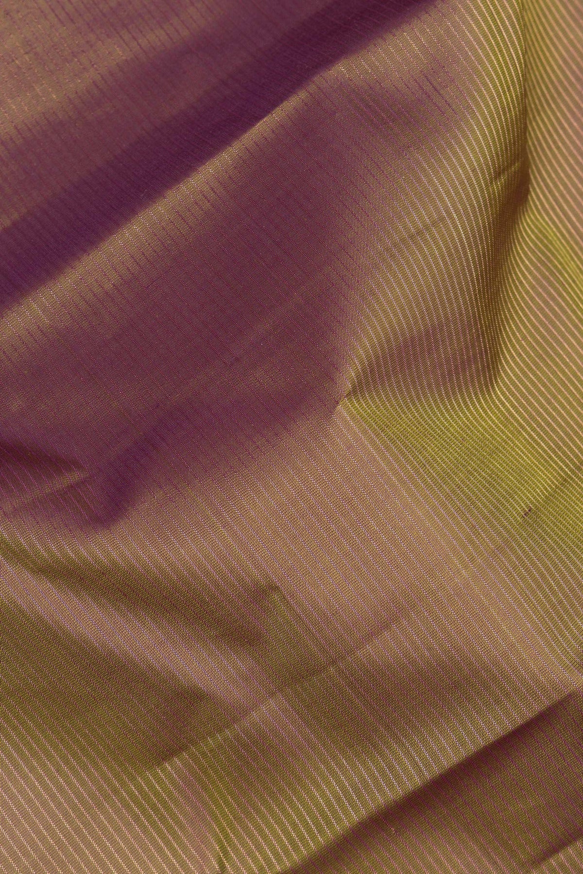 Close up of Pure Silk Mehandi Green Dual Tone Kanchipuram Saree with Stripes on the body and Fancy Border.  displaying folds