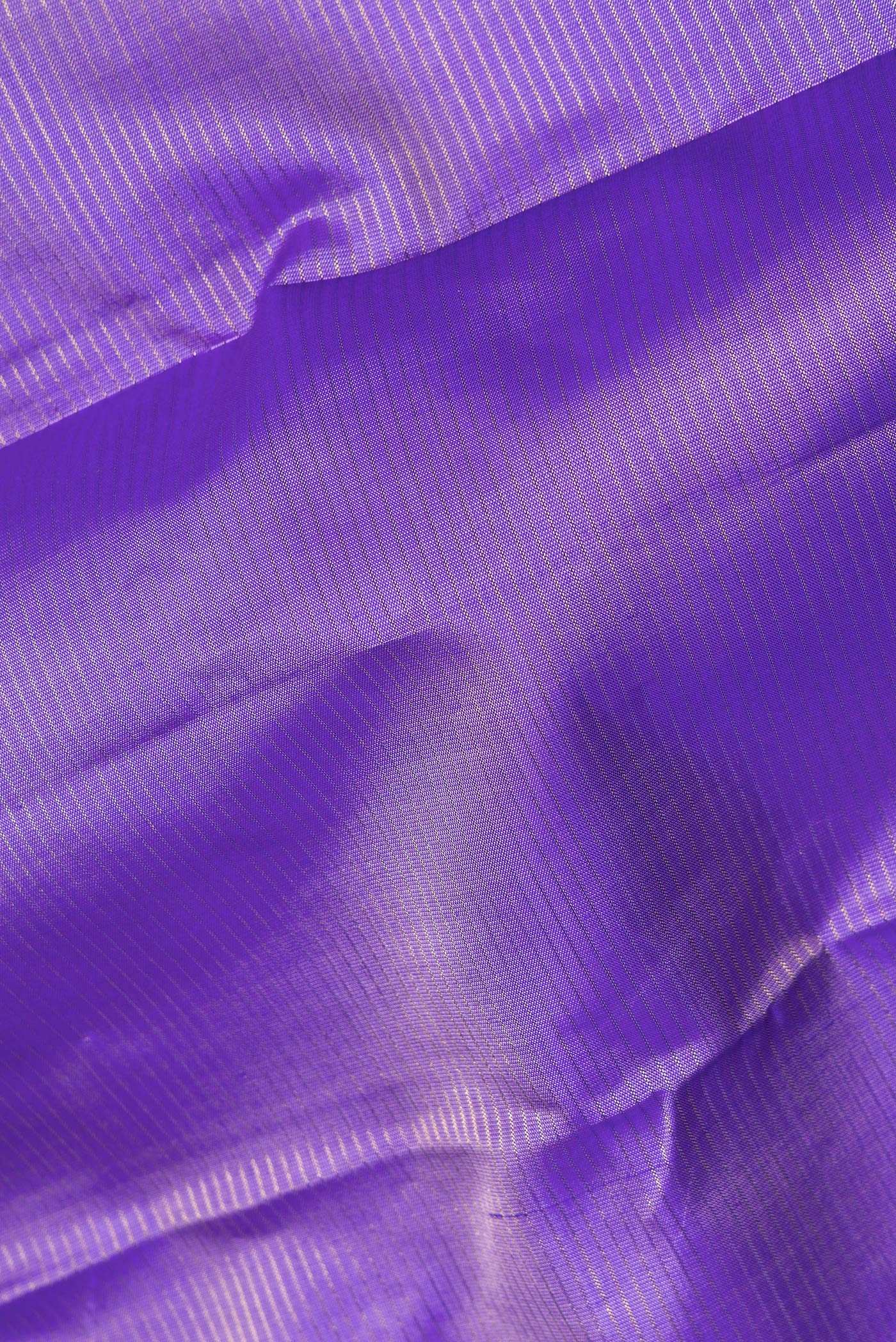 Close up of Pure Silk Lavender Kanchipuram Saree with Stripes on the body and Fancy Border.  displaying folds
