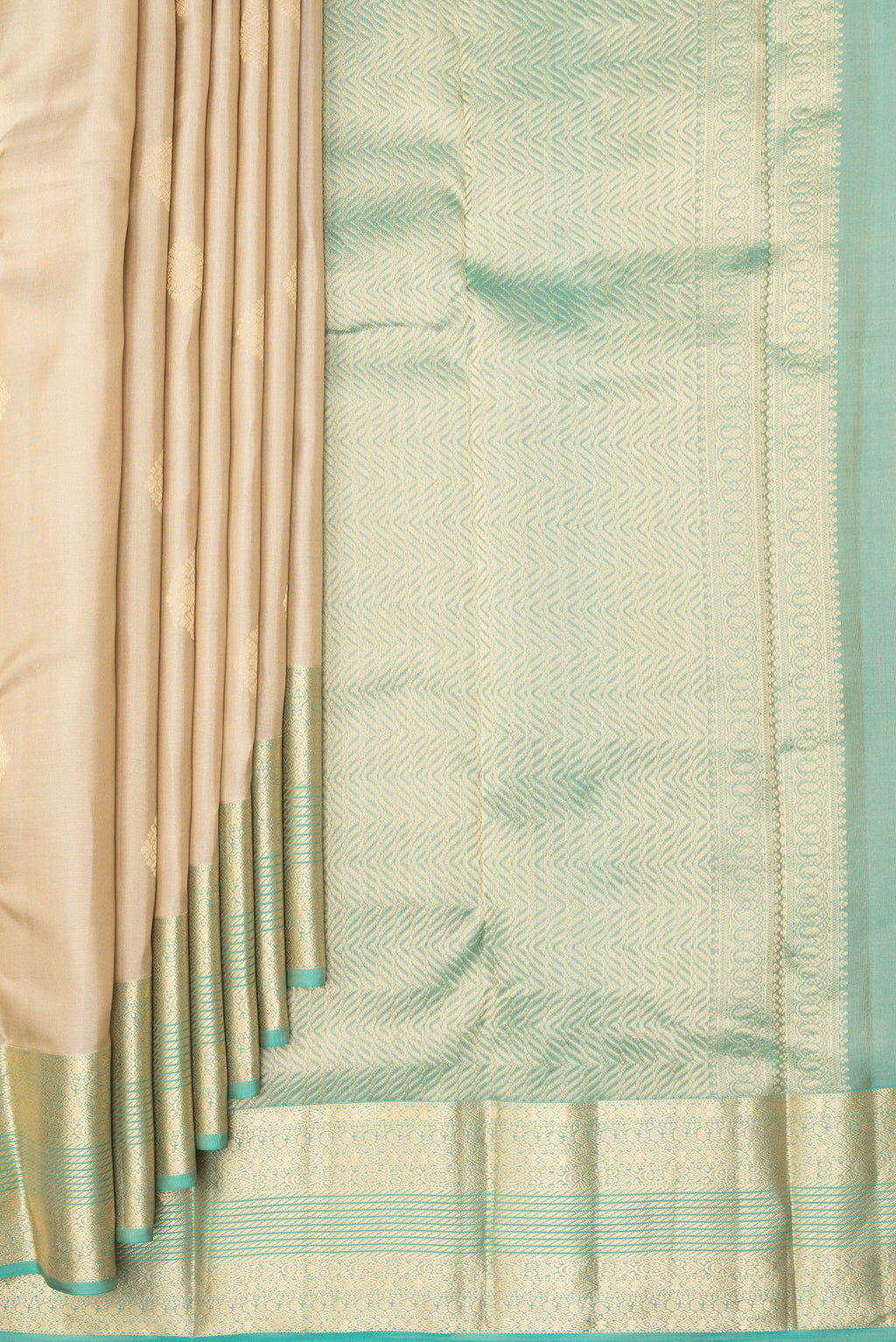 Pleats and pallu of Pure Silk Beige Kanchipuram Saree with Zari Butta on the body and Zari Border. 