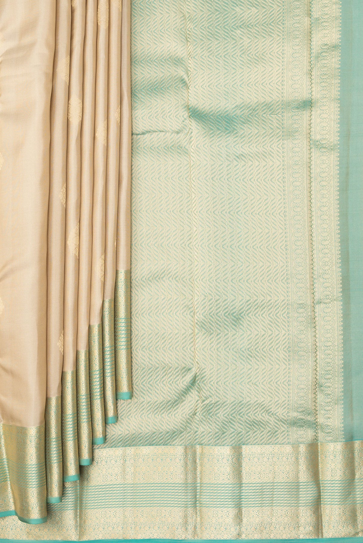 Pleats and pallu of Pure Silk Beige Kanchipuram Saree with Zari Butta on the body and Zari Border. 