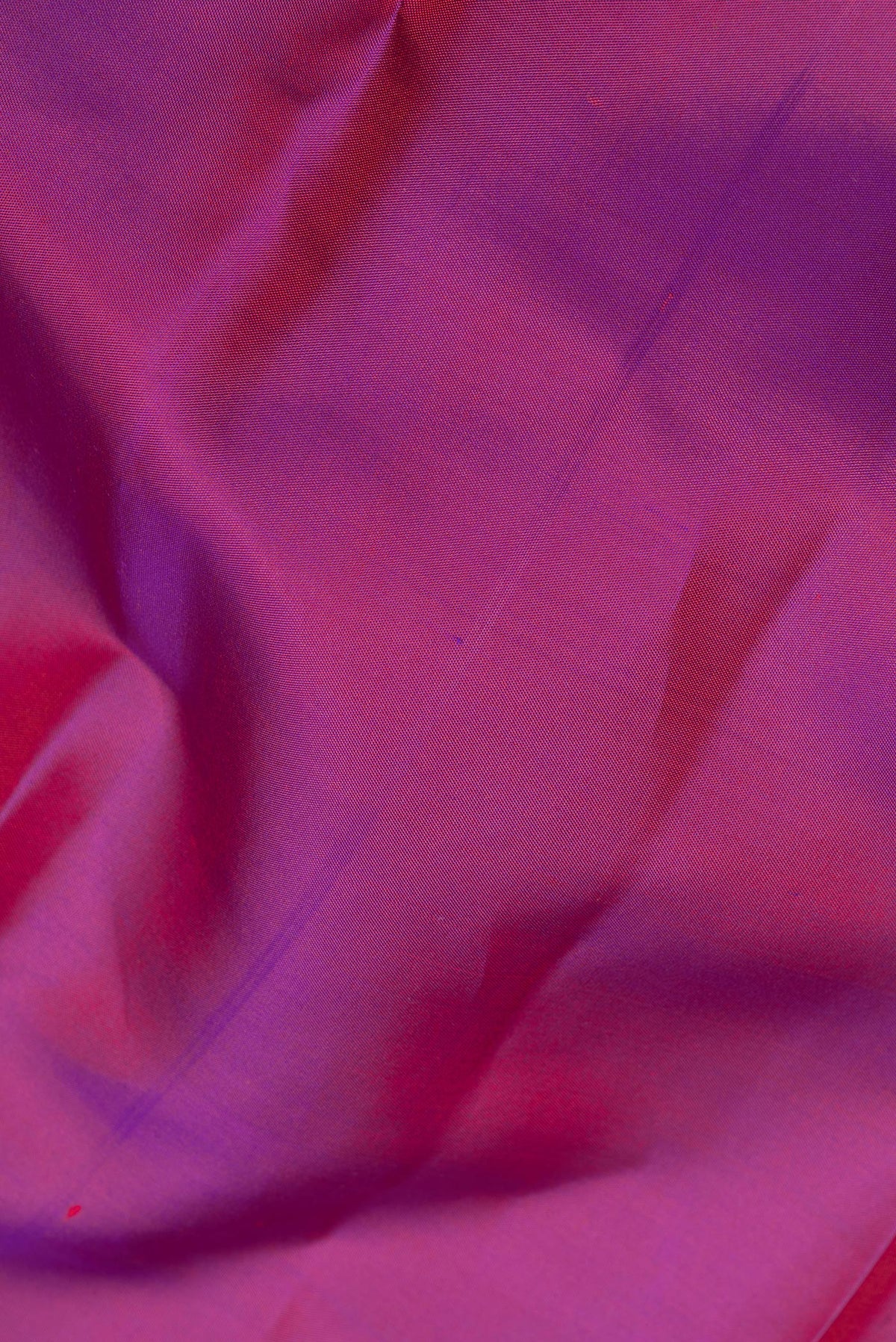 Close up of Pure Silk Purple Dual Tone Kanchipuram Saree with Plain Body and Zari Border.  displaying folds