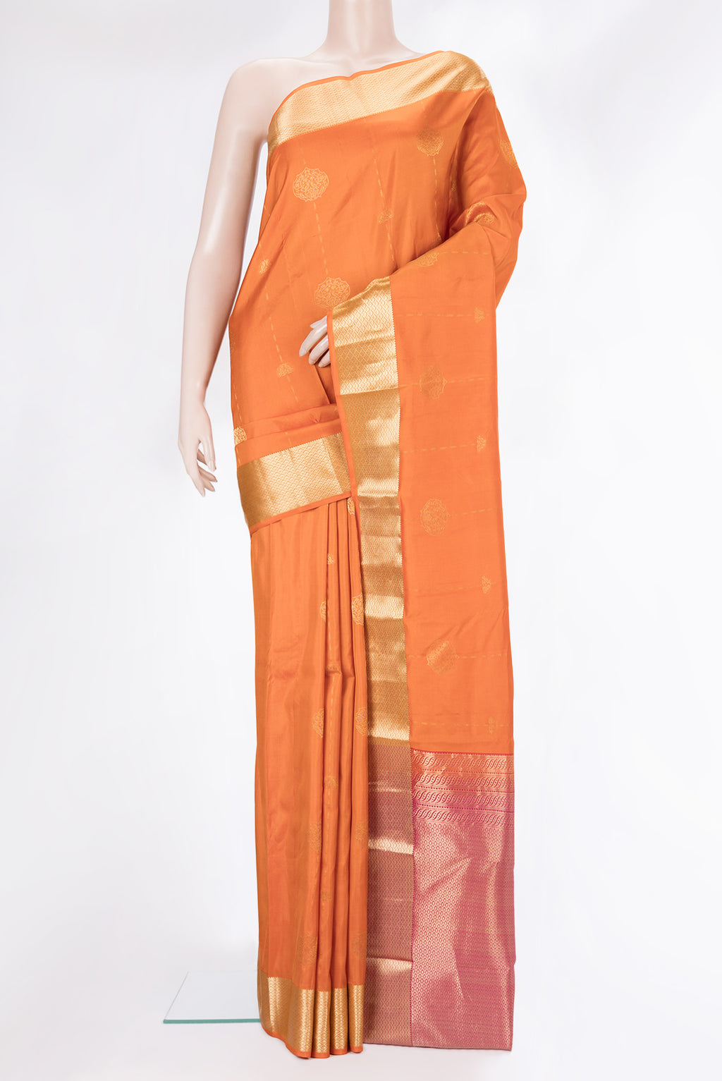 Pure Silk Orange Kanchipuram Saree with Zari Butta on the body and Zari Border.  displayed on a mannequin