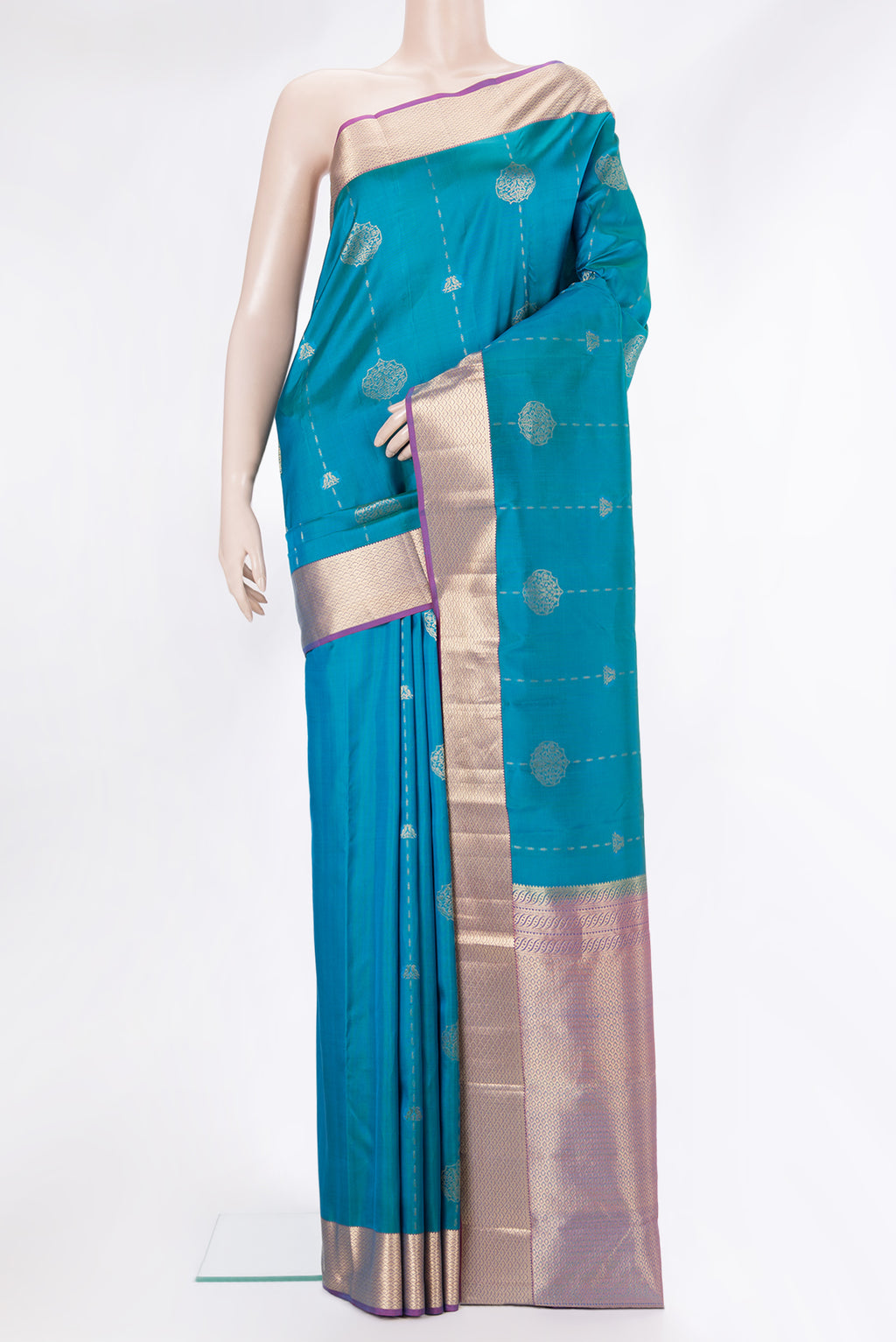 Pure Silk Peacock Blue Kanchipuram Saree with Zari Butta on the body and Zari Border.  displayed on a mannequin
