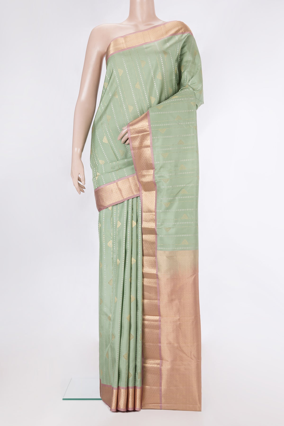 Pure Silk Pista Green Kanchipuram Saree with Zari Butta on the body and Zari Border.  displayed on a mannequin