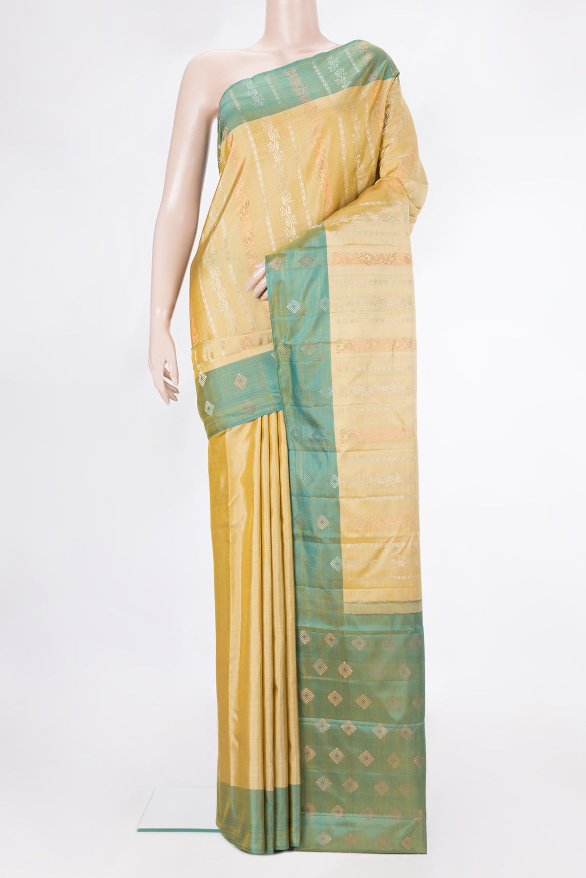 Pure Silk Mustard Kanchipuram Saree with Zari Butta on the body and Zari Border.  displayed on a mannequin