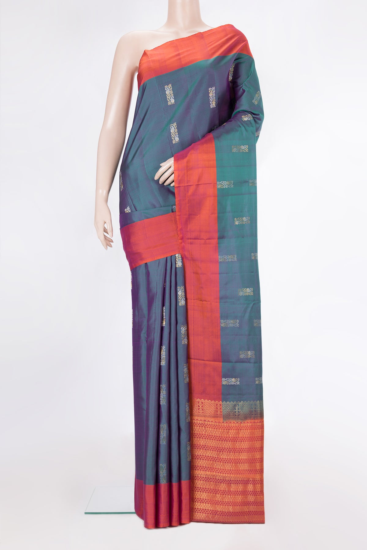 Pure Silk Peacock Blue Dual Tone Kanchipuram Saree with Zari Butta on the body and Plain Border.  displayed on a mannequin