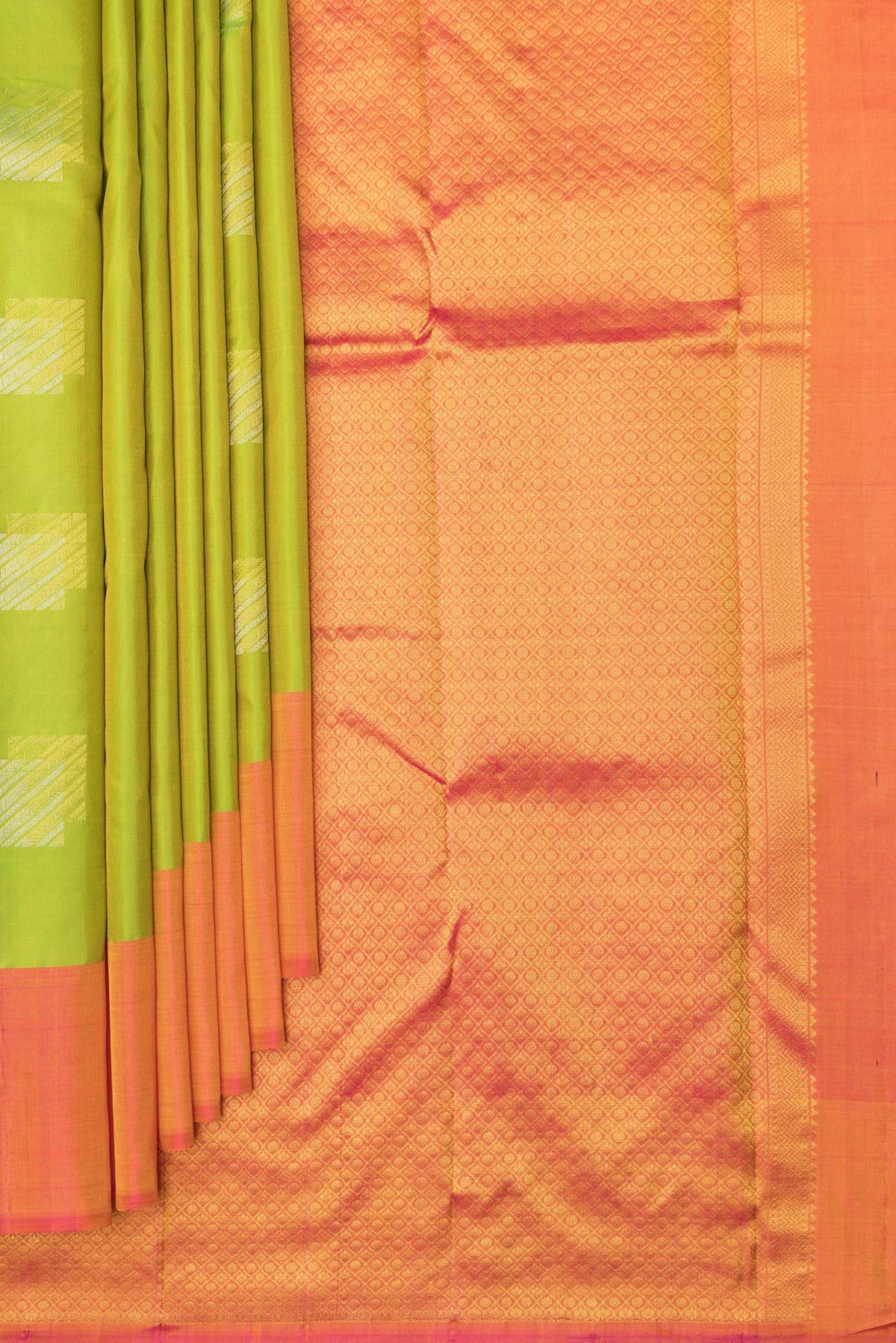 Pleats and pallu of Pure Silk Parrot Green Kanchipuram Saree with Zari Butta on the body and Plain Border. 