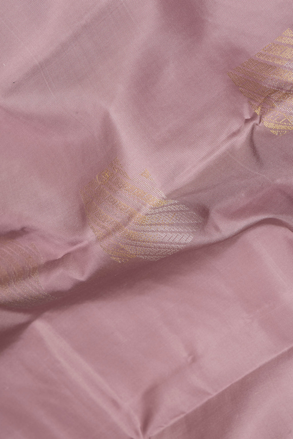 Close up of Pure Silk Mauve Kanchipuram Saree with Zari Butta on the body and Without Border.  displaying folds