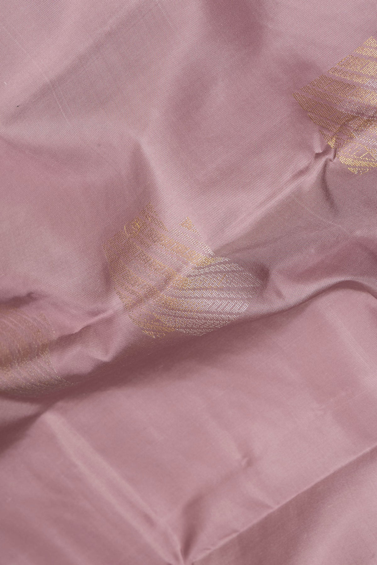 Close up of Pure Silk Mauve Kanchipuram Saree with Zari Butta on the body and Without Border.  displaying folds