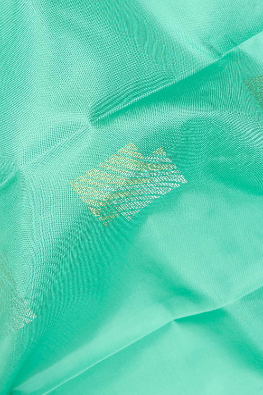 Close up of Pure Silk Sea Green Dual Tone Kanchipuram Saree with Zari Butta on the body and Plain Border.  displaying folds