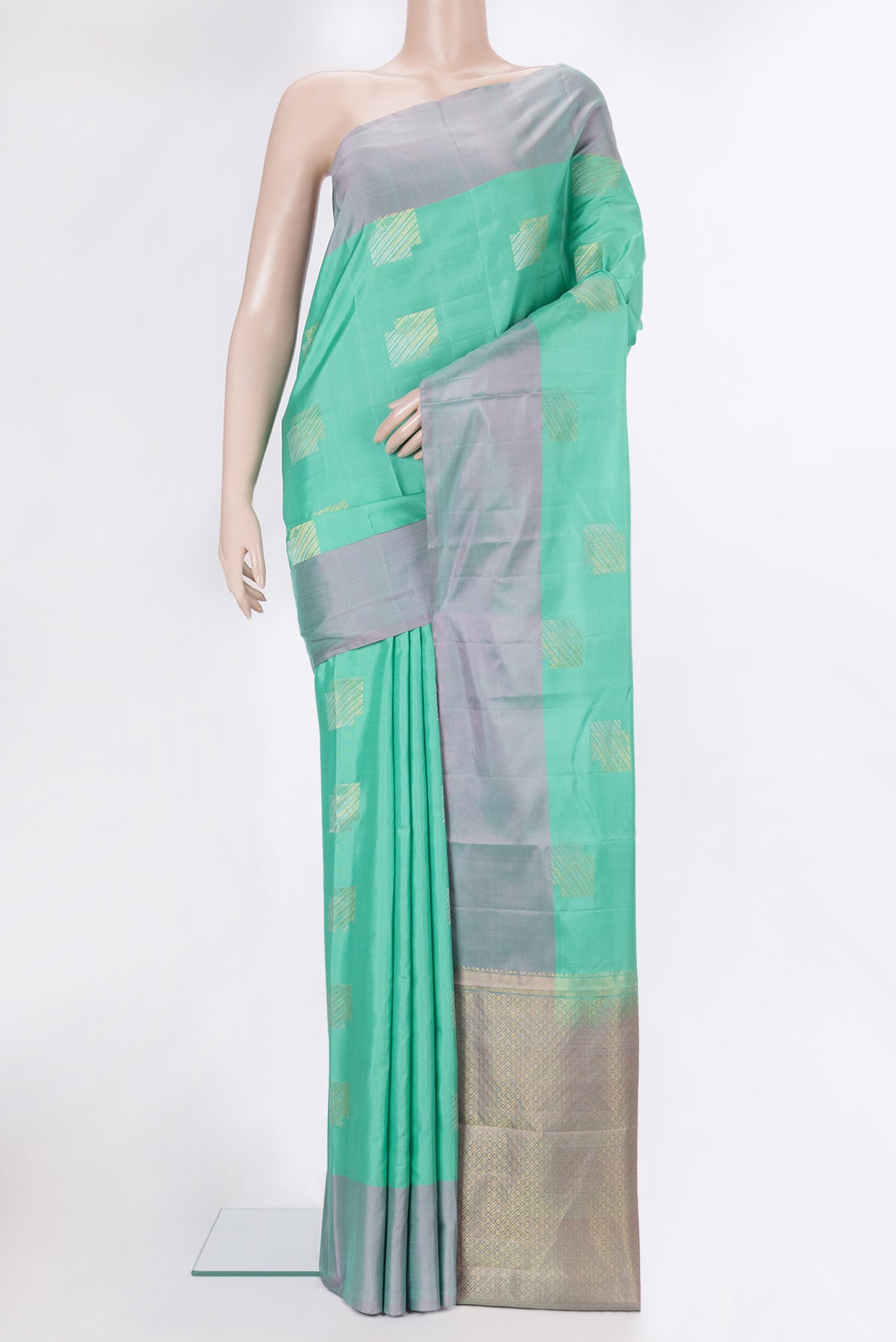 Pure Silk Sea Green Dual Tone Kanchipuram Saree with Zari Butta on the body and Plain Border.  displayed on a mannequin