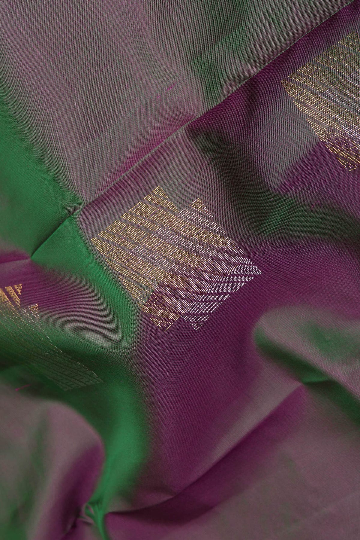 Close up of Pure Silk Green Dual Tone Kanchipuram Saree with Zari Butta on the body and Plain Border.  displaying folds