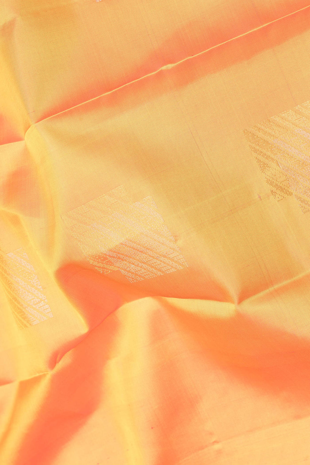 Close up of Pure Silk Mustard Kanchipuram Saree with Zari Butta on the body and Plain Border.  displaying folds