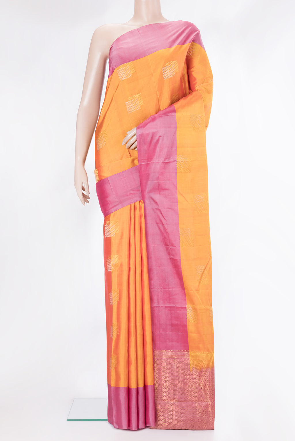 Pure Silk Mustard Kanchipuram Saree with Zari Butta on the body and Plain Border.  displayed on a mannequin