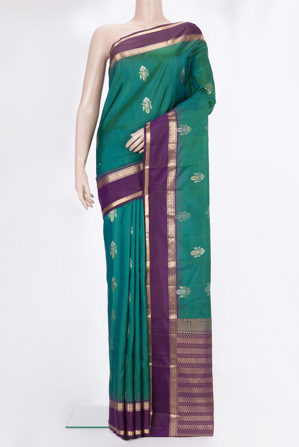 Pure Silk Green Kanchipuram Saree with Zari Butta on the body and Zari Border.  displayed on a mannequin