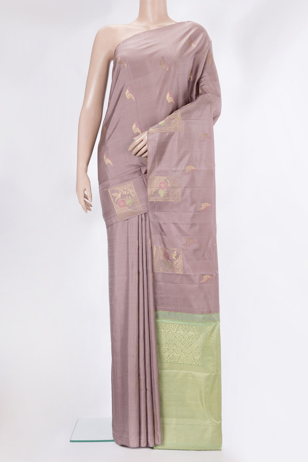 Pure Silk Rose Gold Kanchipuram Saree with Zari Butta on the body and Without Border.  displayed on a mannequin