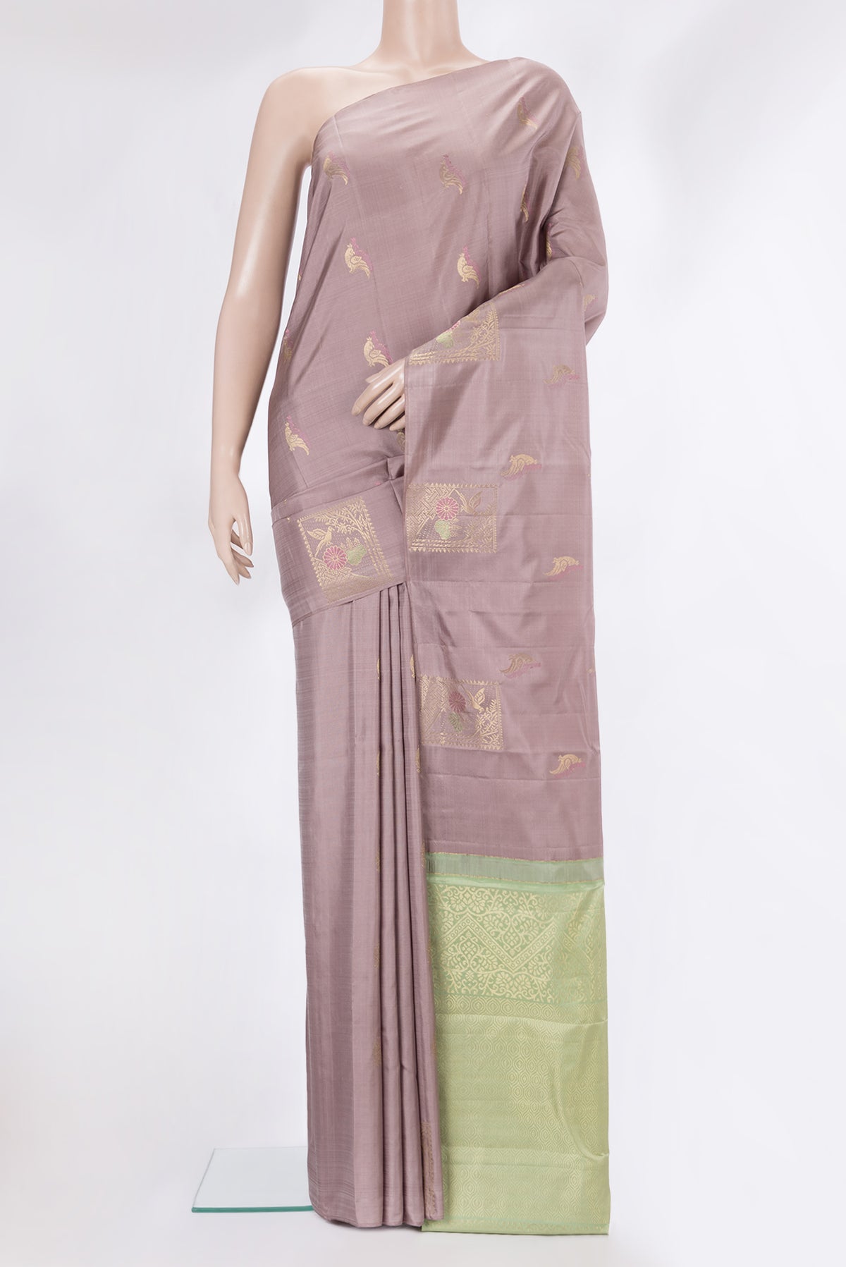 Pure Silk Rose Gold Kanchipuram Saree with Zari Butta on the body and Without Border.  displayed on a mannequin