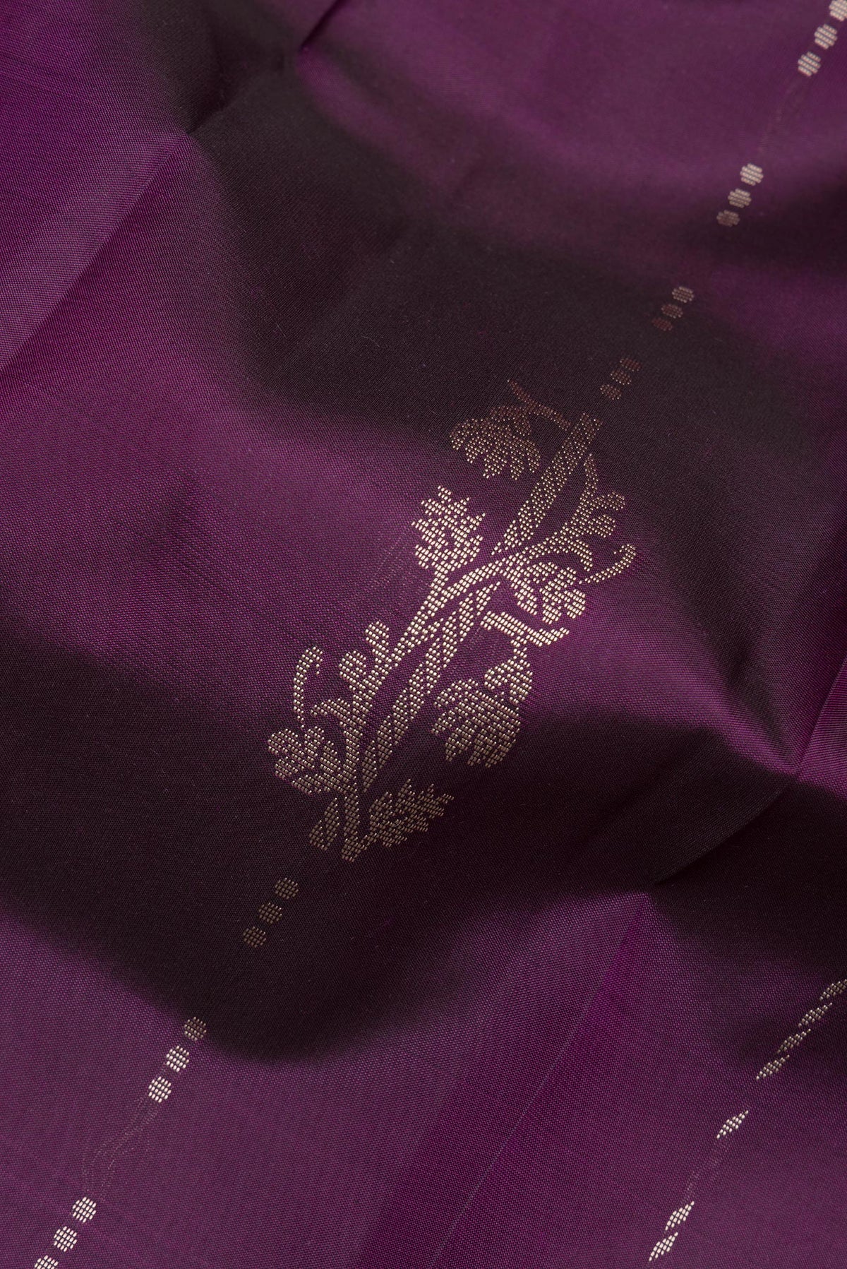 Close up of Pure Silk Purple Kanjivaram Saree with Thread Butta on the body and Thread Border.  displaying folds