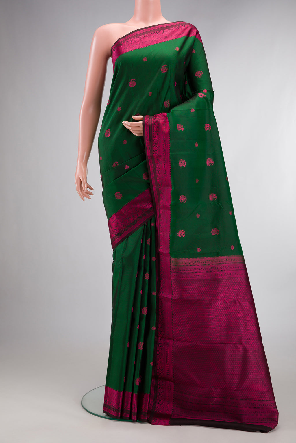 Pure Silk Bottle Green Dual Tone Kanchipuram Saree with Thread Butta on the body and Thread Border.  displayed on a mannequin