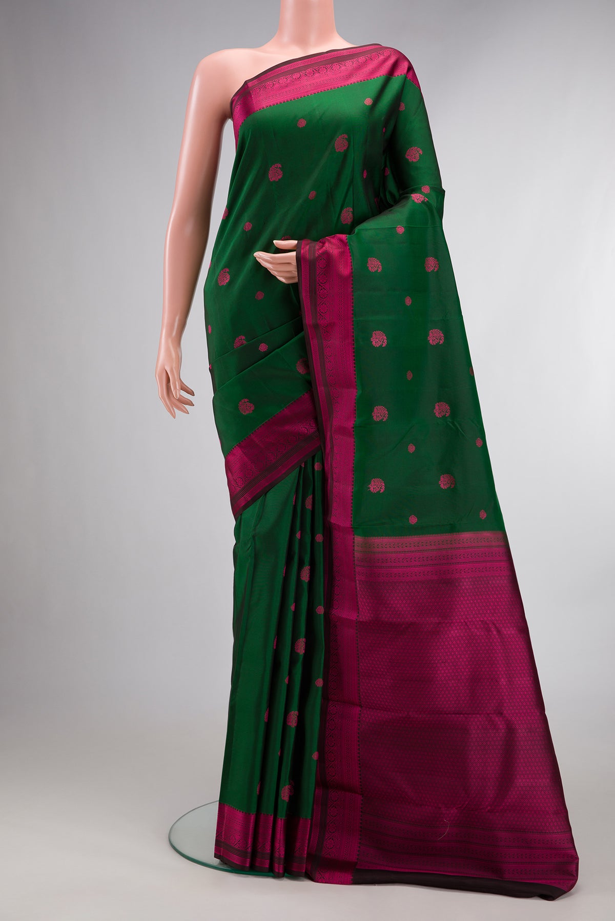 Pure Silk Bottle Green Dual Tone Kanchipuram Saree with Thread Butta on the body and Thread Border.  displayed on a mannequin
