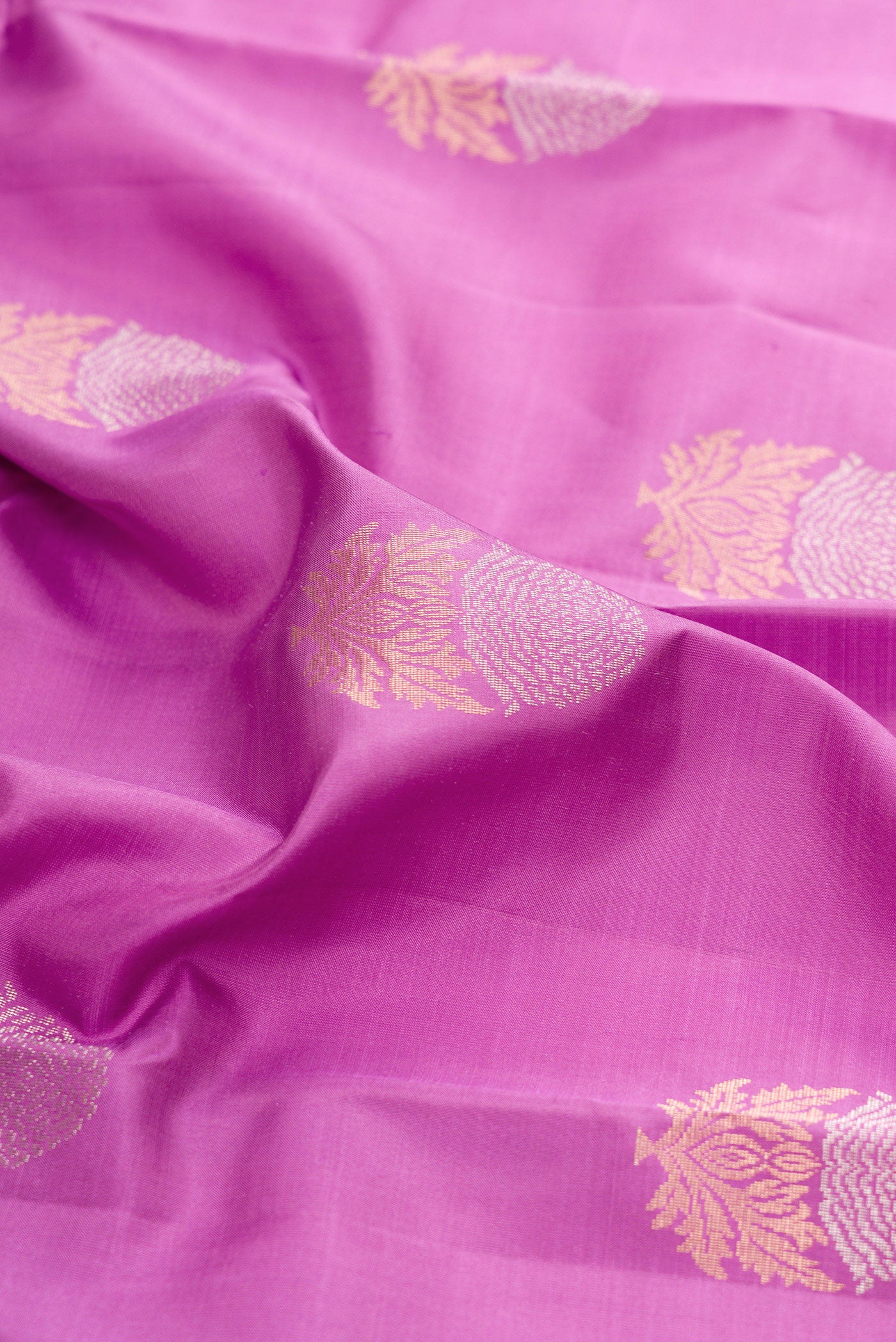 Close up of Lavender Kanchipuram Silk Saree with Zari Butta on the body and Zari Border.  displaying folds