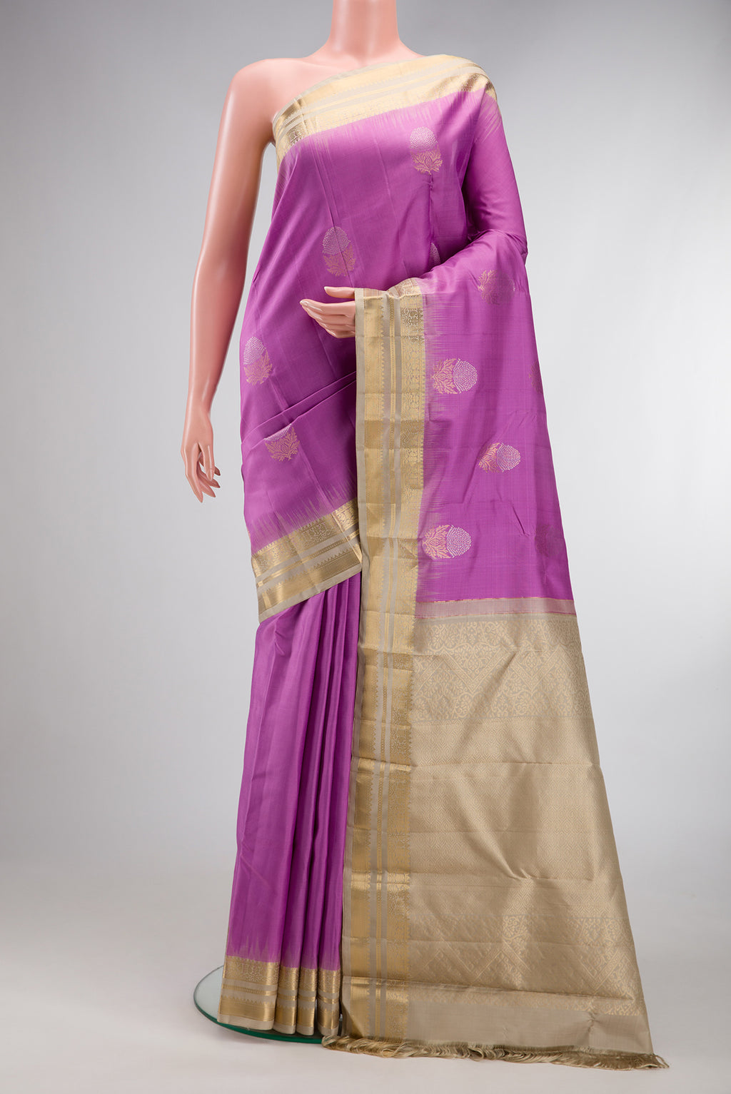 Lavender Kanchipuram Silk Saree with Zari Butta on the body and Zari Border.  displayed on a mannequin