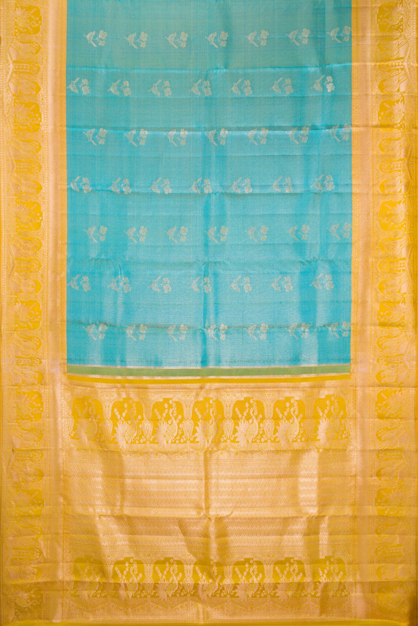 Flat view of Pure Silk Sky Blue Kanchipuram Tissue Saree with Zari Butta on the body and Fancy Border. 