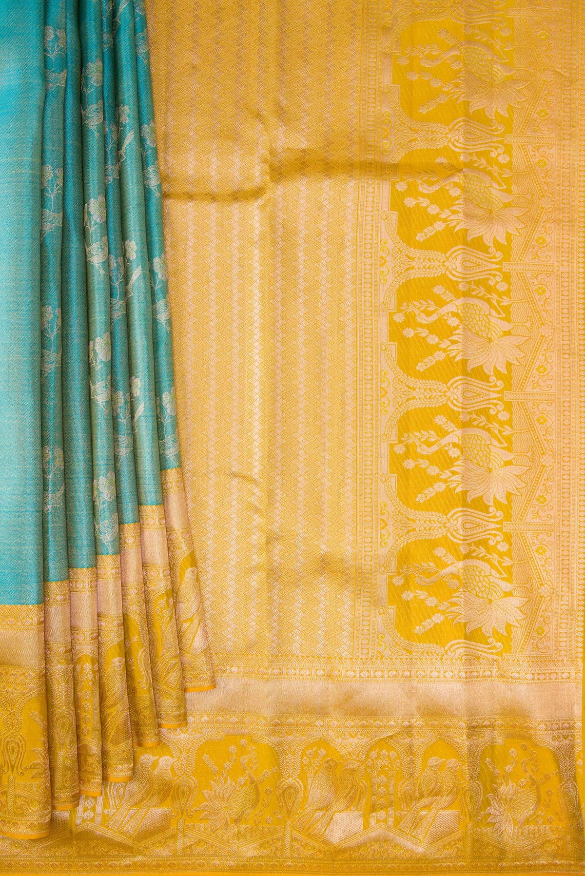 Pleats and pallu of Pure Silk Sky Blue Kanchipuram Tissue Saree with Zari Butta on the body and Fancy Border. 