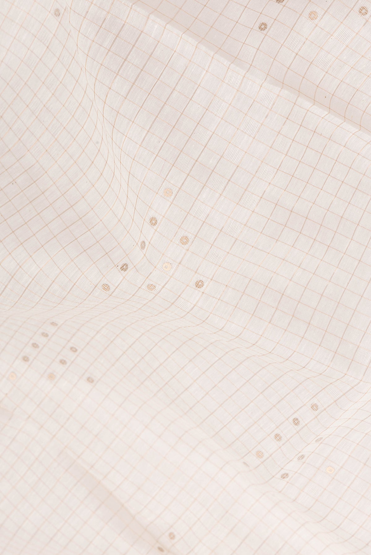 Close up of Pure Silk Beige Dual Tone Maheshwari Saree with Embroidery on the body and Zari Border.  displaying folds