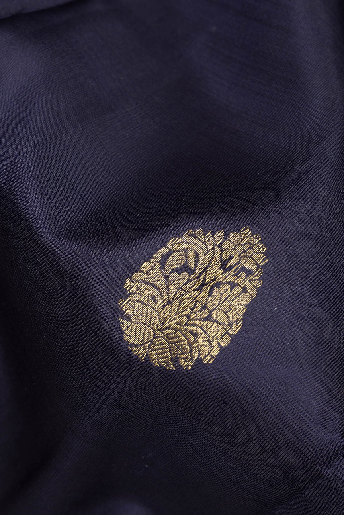 Close up of Pure Silk Navy Blue Kanjivaram Saree with Zari Butta on the body and Zari Border.  displaying folds
