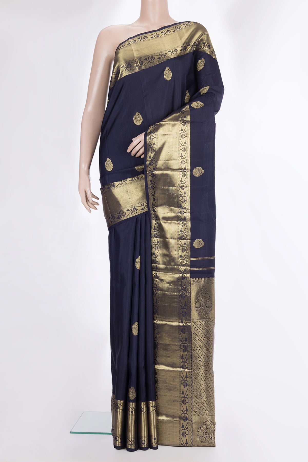 Pure Silk Navy Blue Kanjivaram Saree with Zari Butta on the body and Zari Border.  displayed on a mannequin