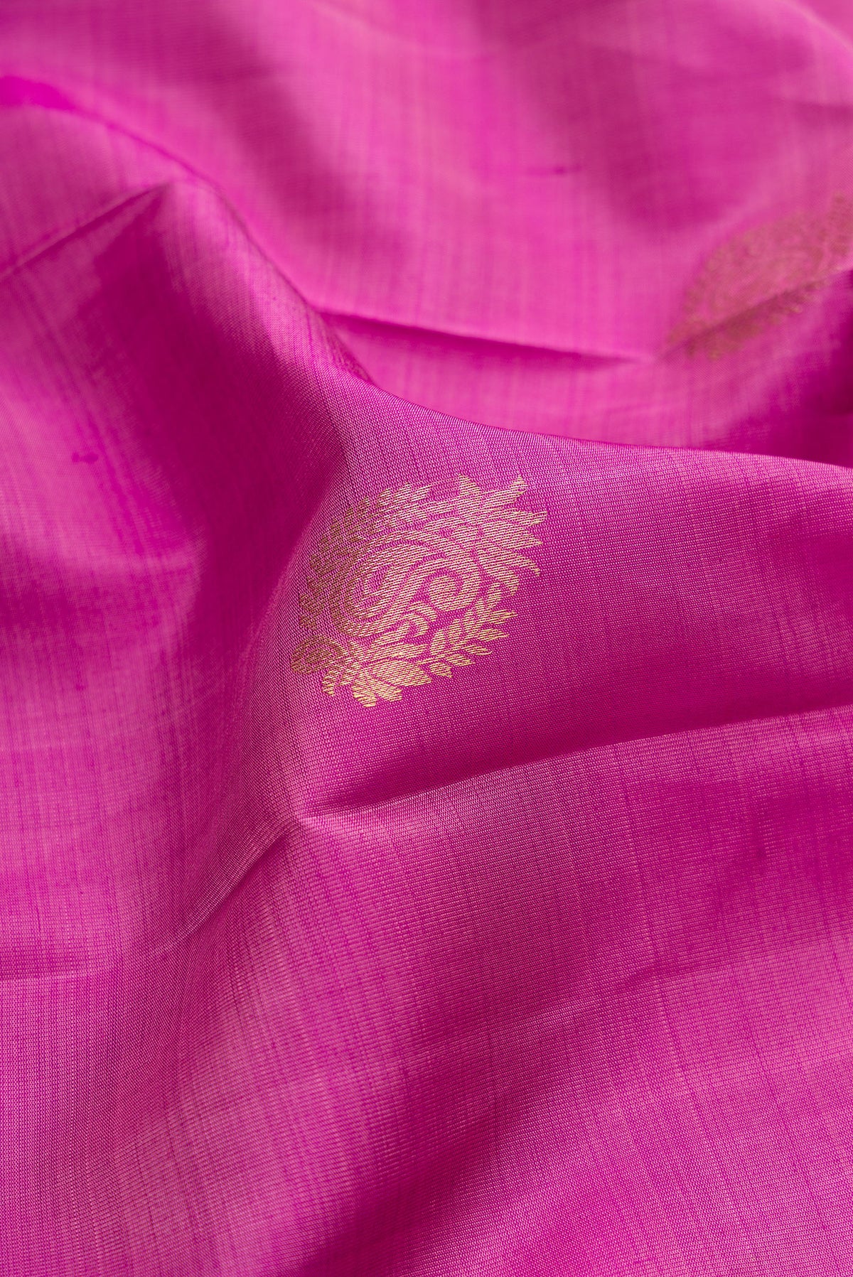 Close up of Pure Silk Light Magenta Kanjivaram Saree with Zari Butta on the body and Zari Border.  displaying folds