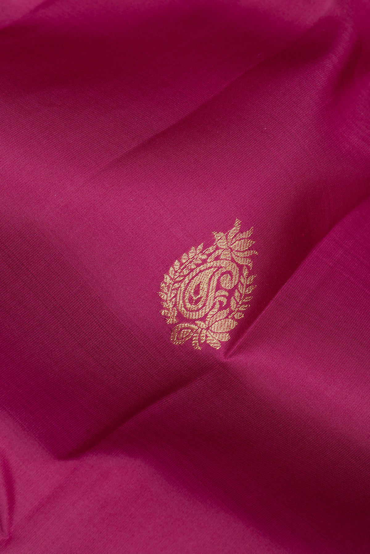 Close up of Pure Silk Maroon Kanjivaram Saree with Zari Butta on the body and Zari Border.  displaying folds